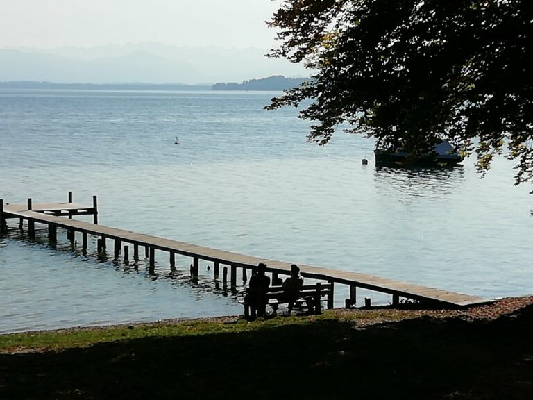 People enjoying the view of Lake Starnberg at the beach cafe